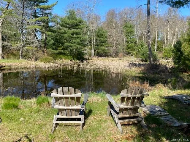 a view of a lake with a bench in front of house