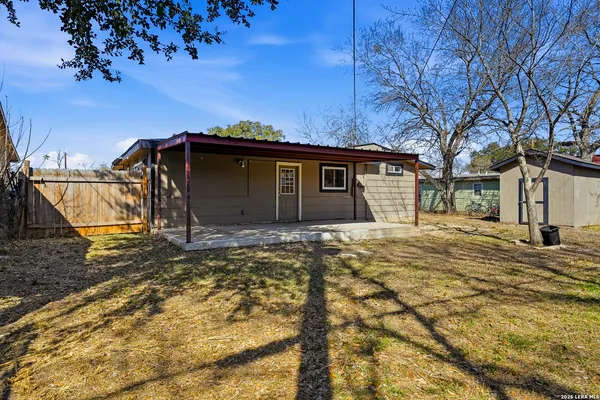 a view of a house with a backyard
