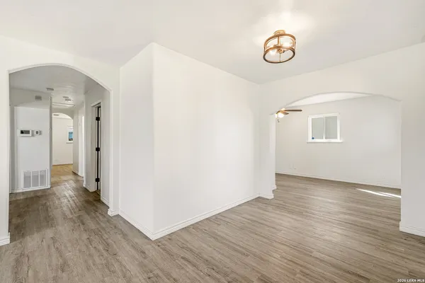 a view of a hallway with wooden floor