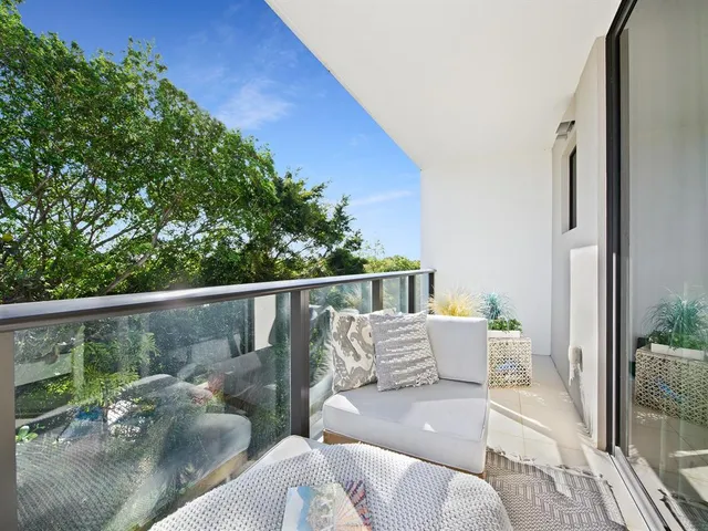a balcony with furniture and wooden floor