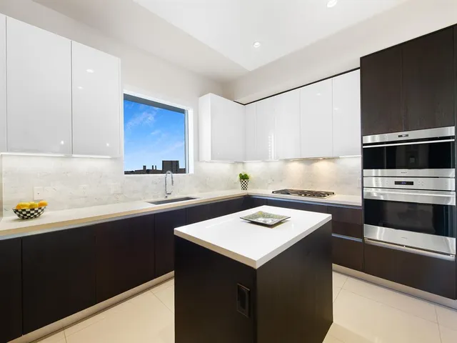 a kitchen with a sink stove and microwave