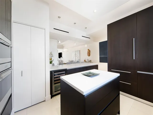 a kitchen with a sink a stove and refrigerator