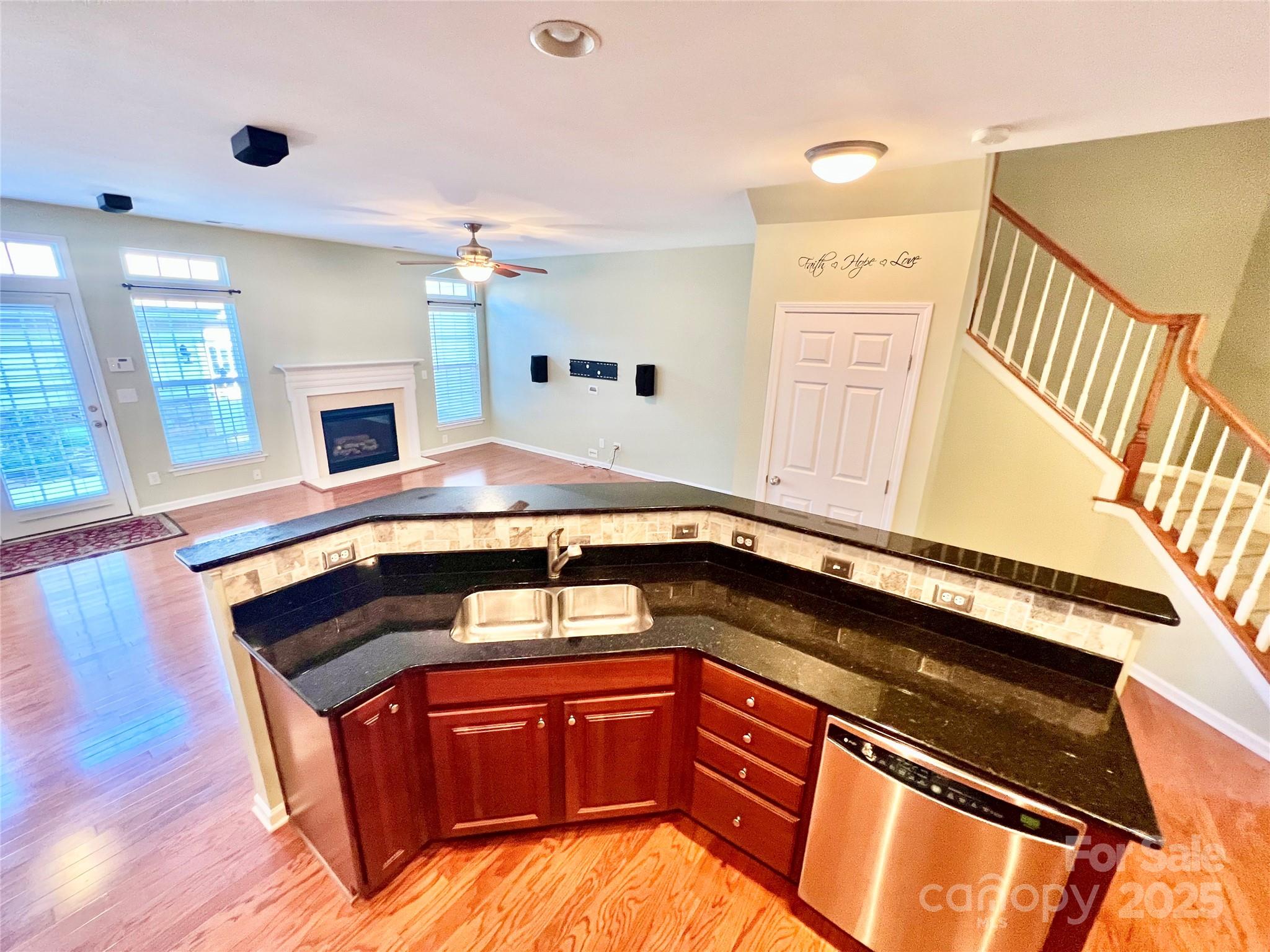 8326 Viewpoint Lane, Unit 802 Cornelius, NC 28031 - Photo 13 of 43 a kitchen with stainless steel appliances granite countertop a sink a stove and a wooden floors
