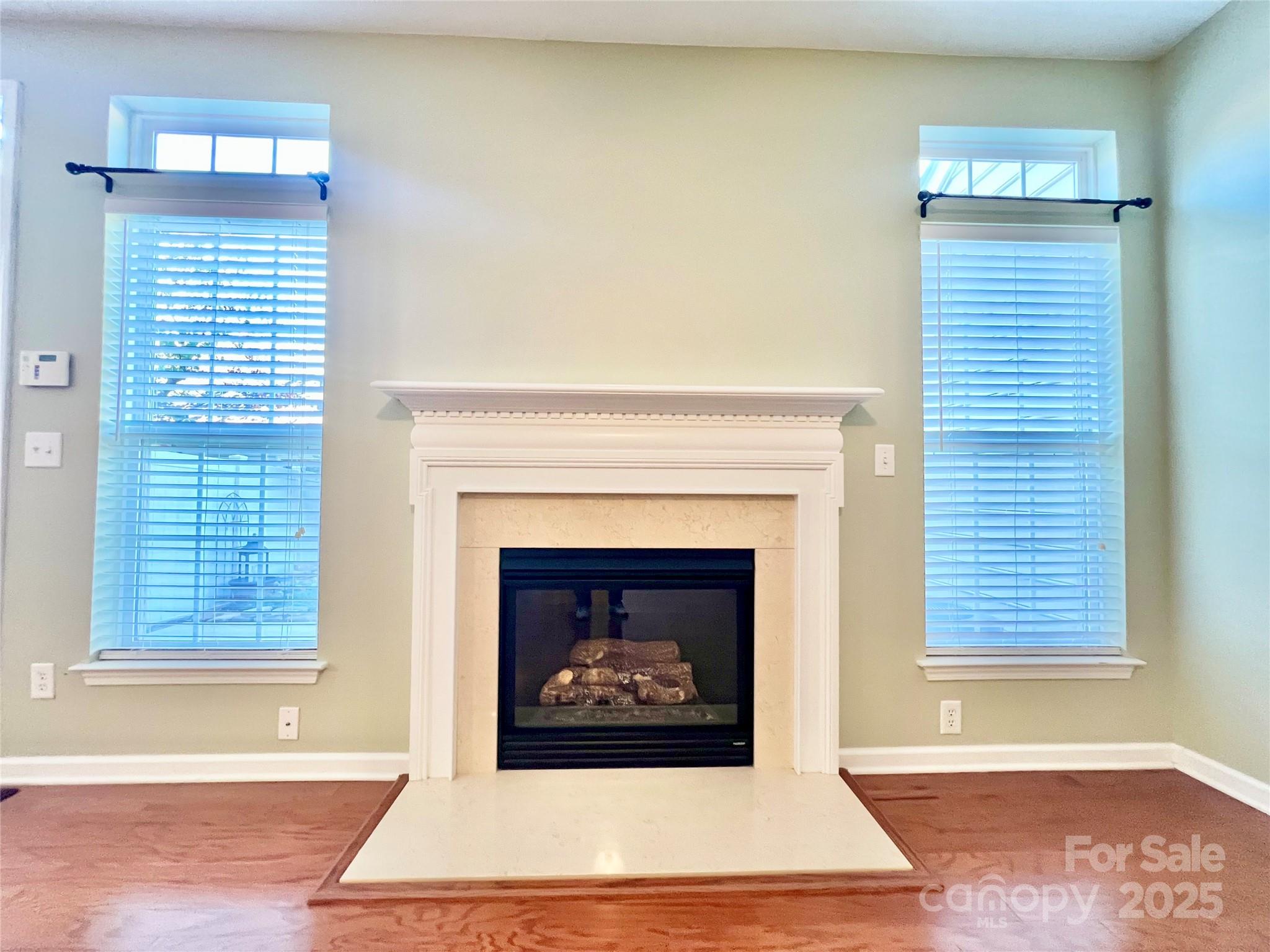 8326 Viewpoint Lane, Unit 802 Cornelius, NC 28031 - Photo 17 of 43 a living room with a fireplace and a window
