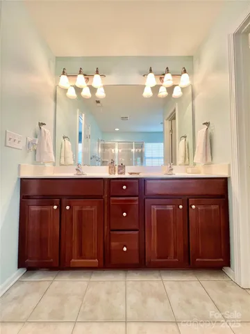 a bathroom with a toilet a sink and a large mirror