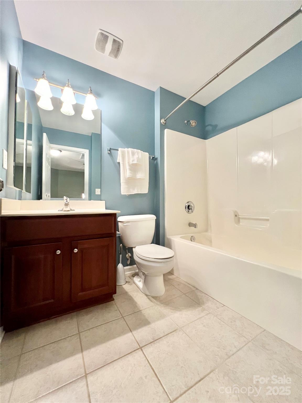 8326 Viewpoint Lane, Unit 802 Cornelius, NC 28031 - Photo 29 of 43 a bathroom with a toilet a sink and a large mirror