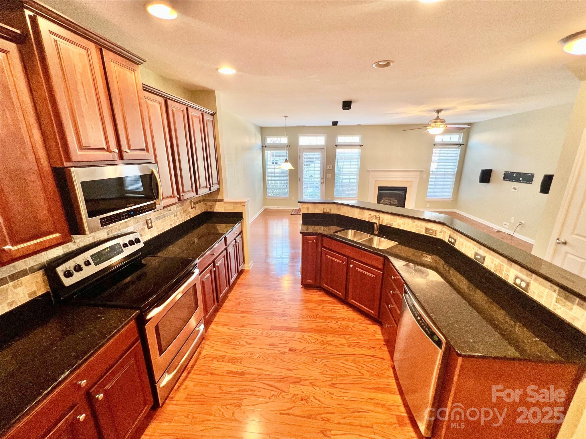 8326 Viewpoint Lane, Unit 802 Cornelius, NC 28031 - Photo 10 of 43 a large kitchen with stainless steel appliances granite countertop a stove and a sink