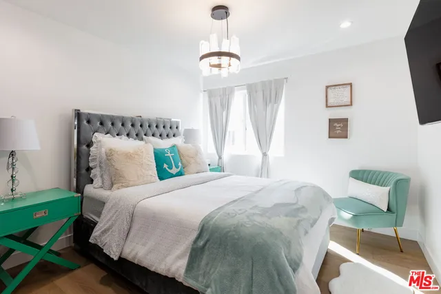 a bedroom with bed and a window