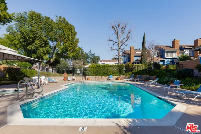 a view of yard with swimming pool and sitting area