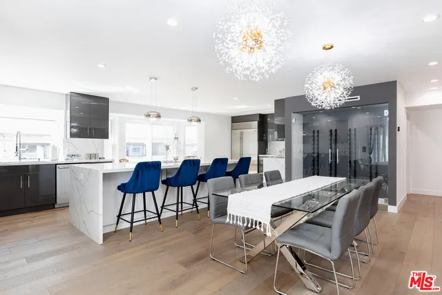 a view of a dining room with furniture and chandelier