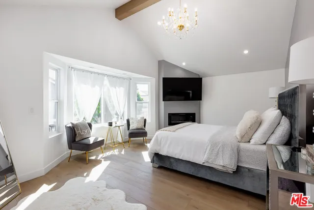 a bedroom with a bed couch and window