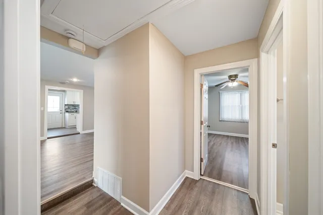 a view of a hallway with wooden floor