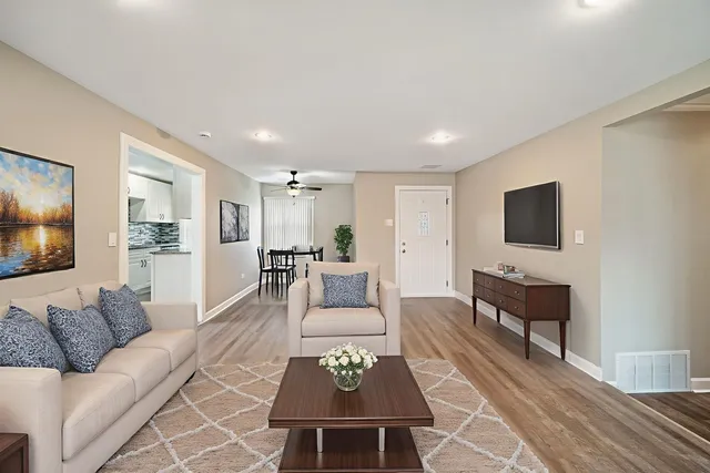 a living room with furniture a rug and a flat screen tv