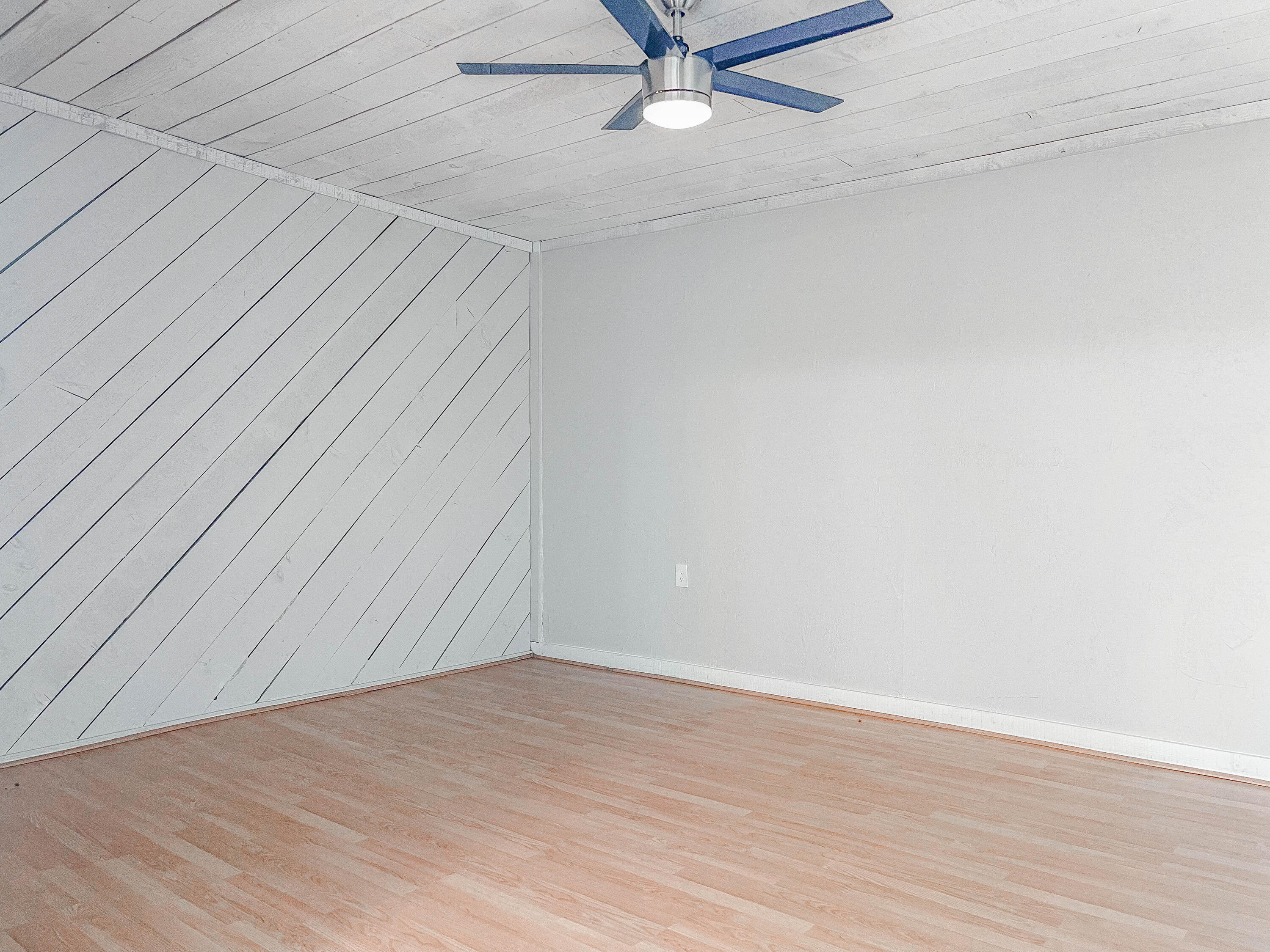 2503 46th Street Lubbock, TX 79413 - Photo 2 of 6 an empty room with wooden floor and fan