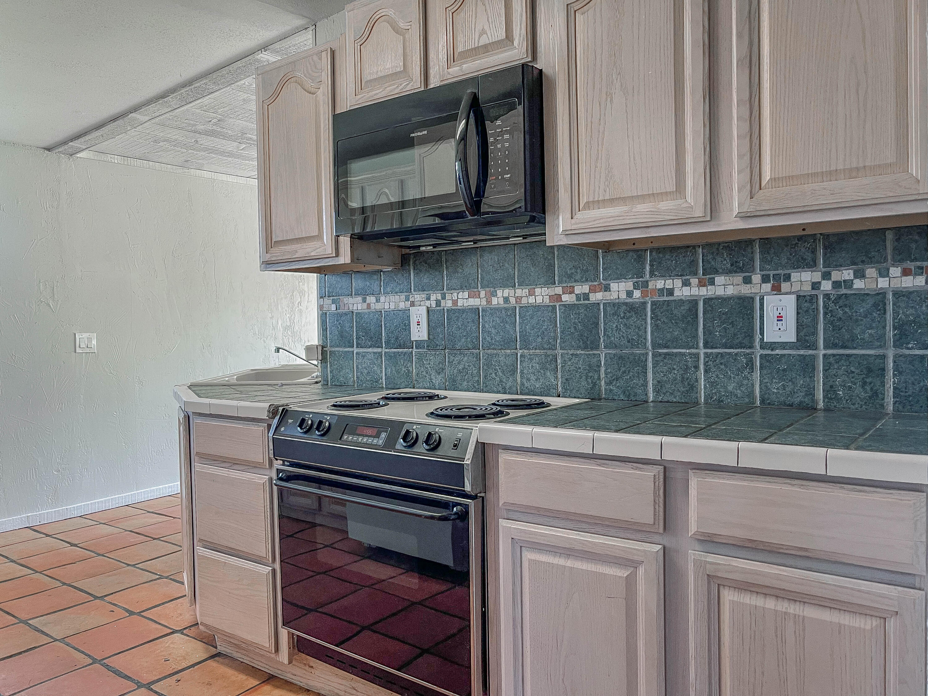 2503 46th Street Lubbock, TX 79413 - Photo 3 of 6 a kitchen with stainless steel appliances granite countertop a stove and a microwave