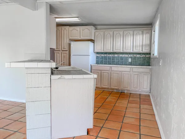 a kitchen with a white stove top oven and white cabinets