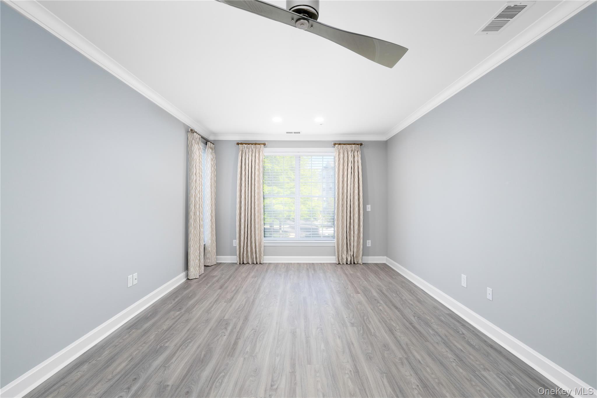 326 Regency Drive Fishkill, NY 12524 - Photo 12 of 24 a view of an empty room with wooden floor and a window