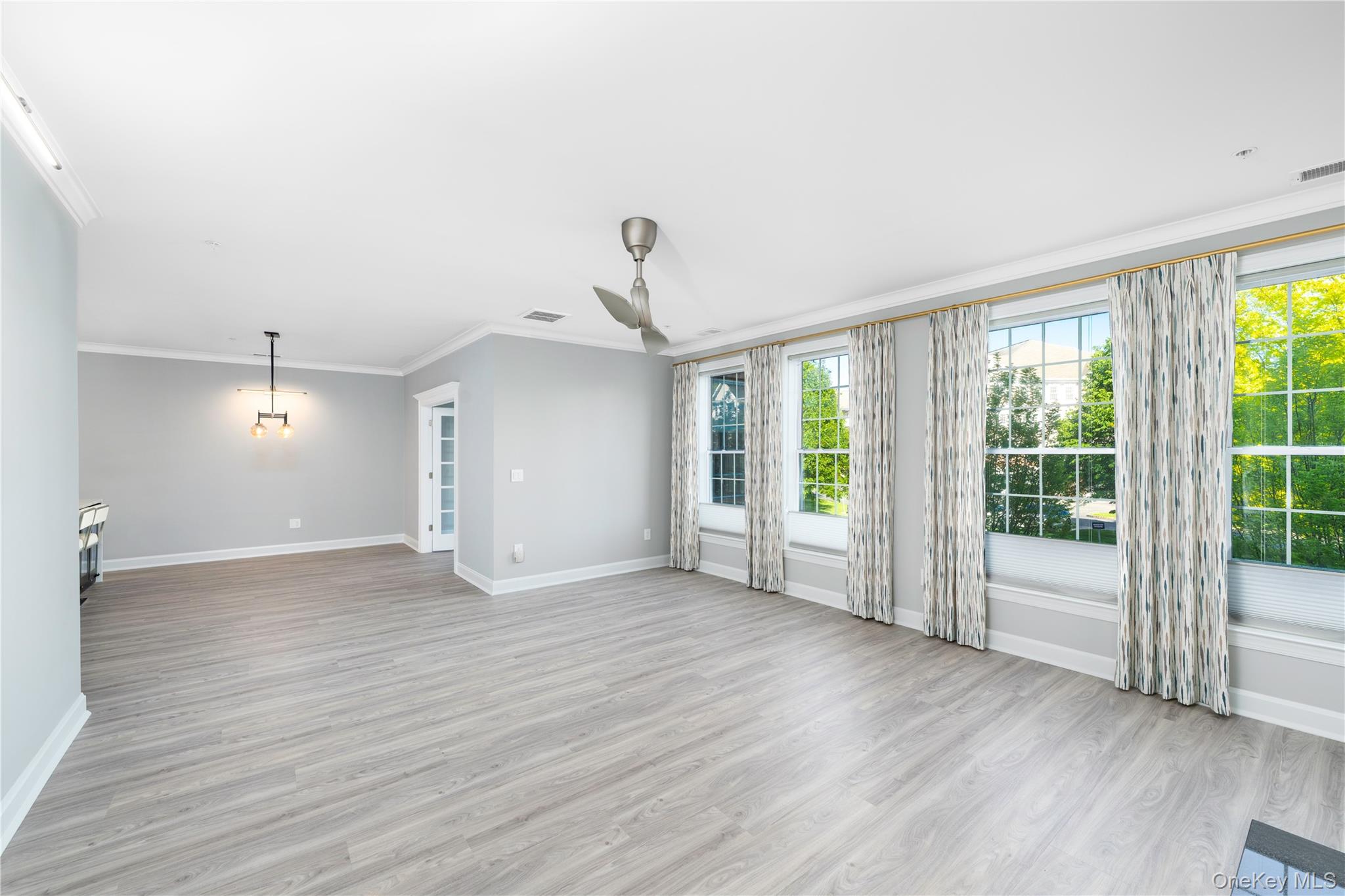 326 Regency Drive Fishkill, NY 12524 - Photo 10 of 24 a view of an empty room with wooden floor and a window