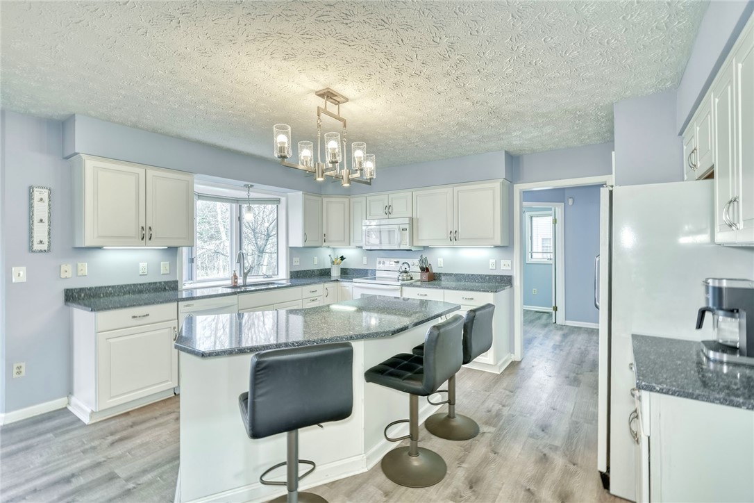 27 Edenfield Road Penfield, NY 14526 - Photo 9 of 48 updated eat-in kitchen with White cabinetry, grani