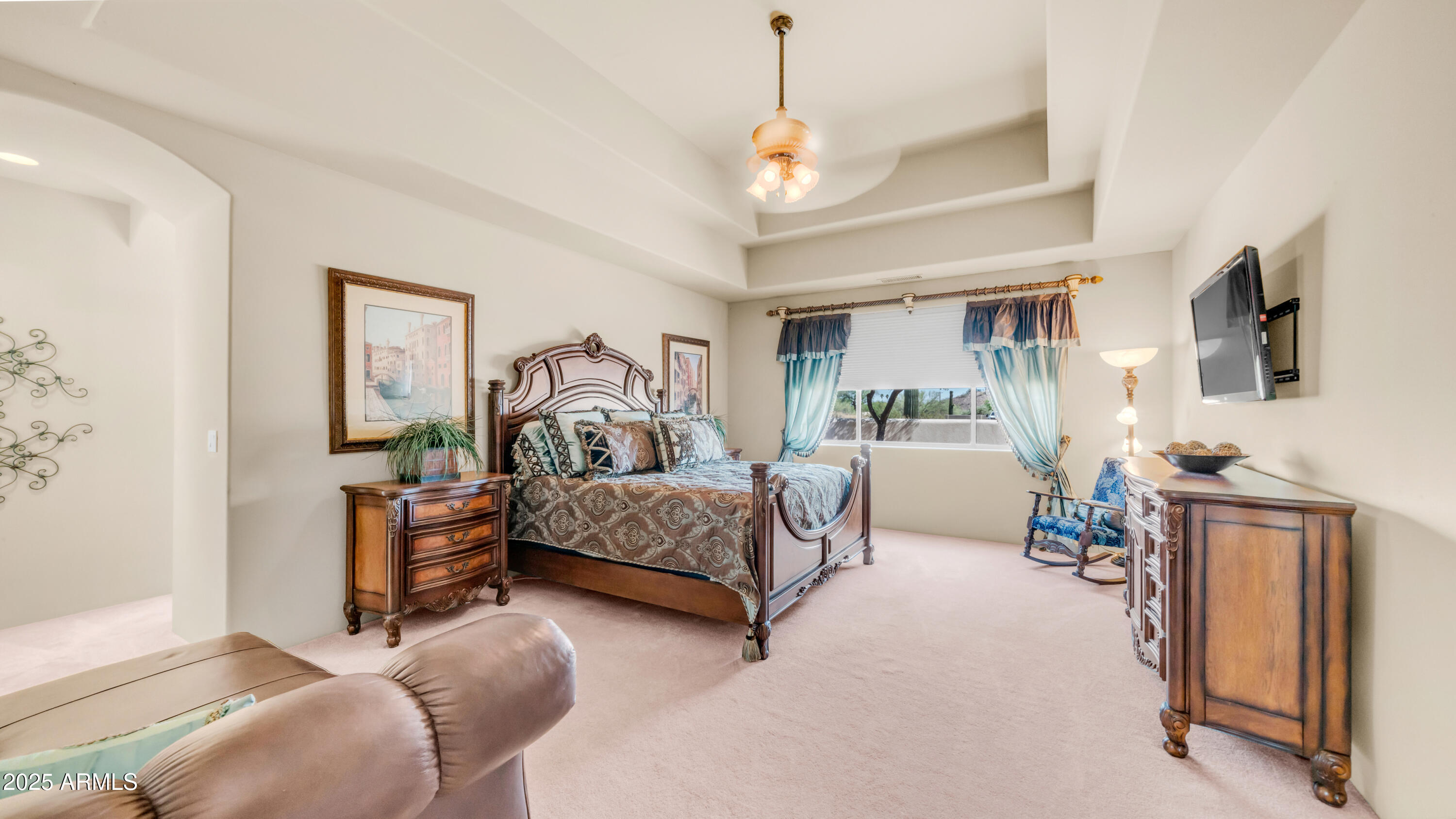 8540 East McDowell Road, Unit 116 Mesa, AZ 85207 - Photo 18 of 64 a bedroom with furniture and a chandelier