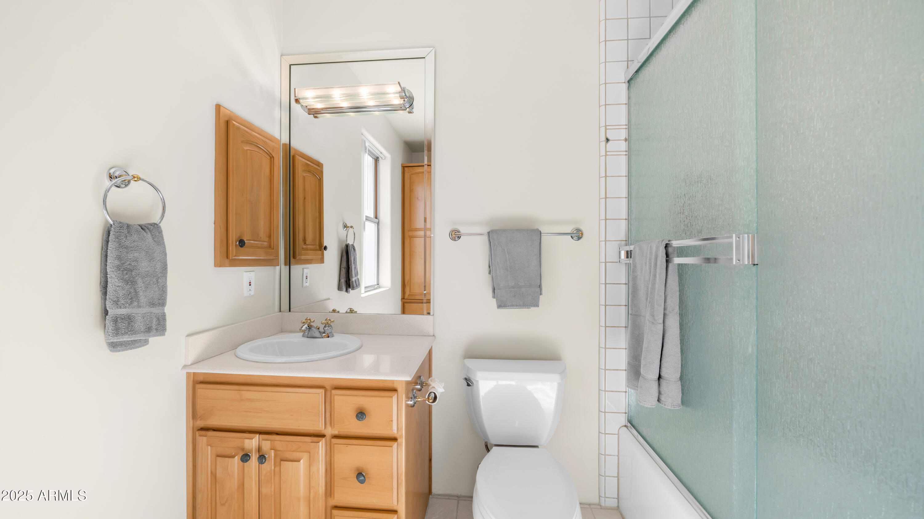 8540 East McDowell Road, Unit 116 Mesa, AZ 85207 - Photo 33 of 64 a bathroom with a toilet sink and mirror