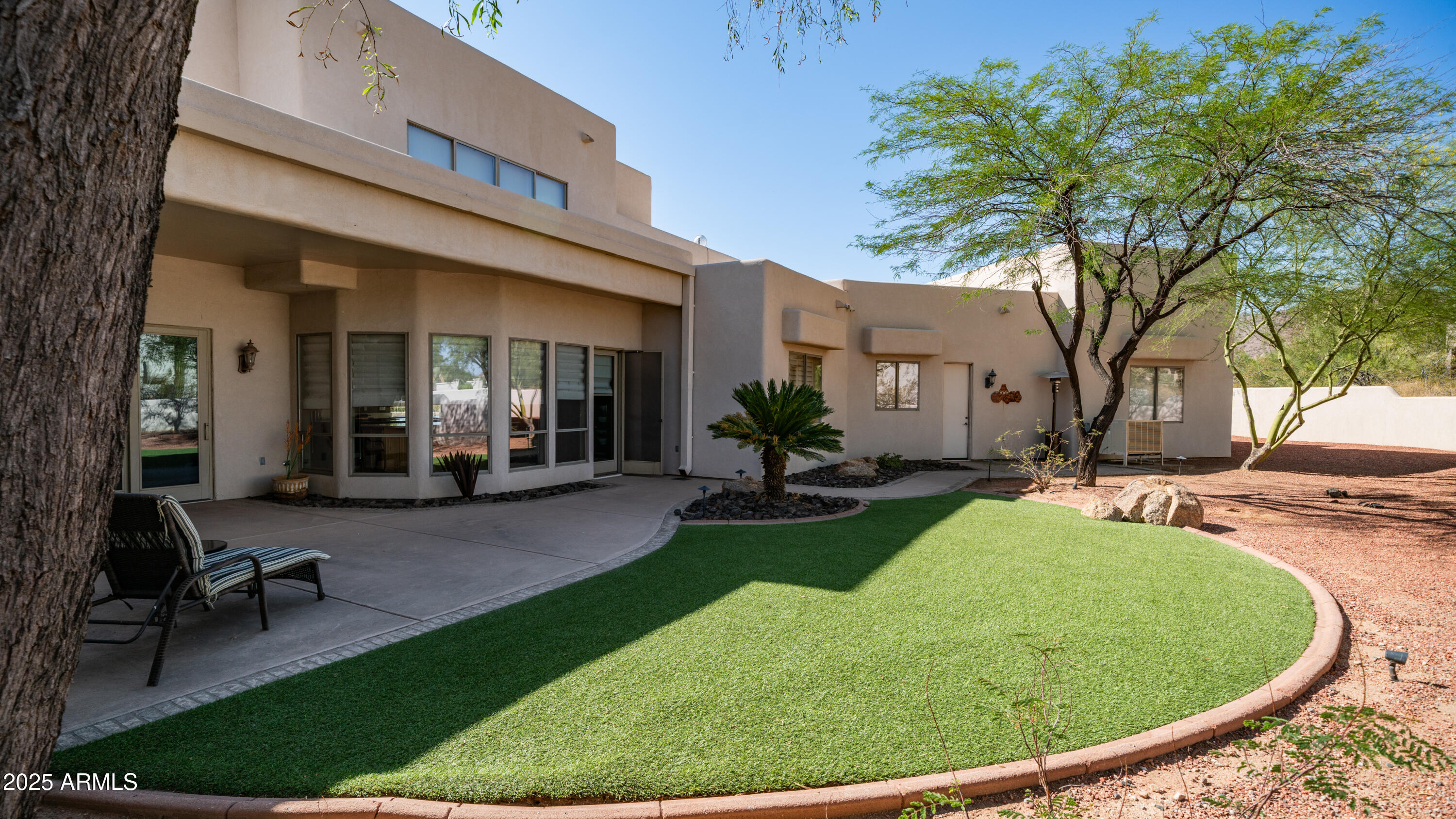 8540 East McDowell Road, Unit 116 Mesa, AZ 85207 - Photo 36 of 64 a view of a house with backyard porch and sitting area