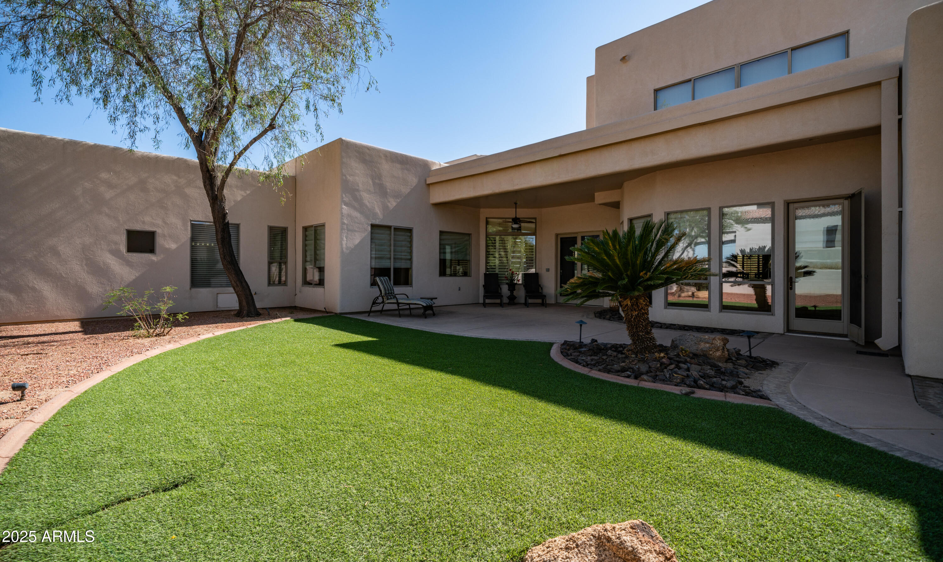 8540 East McDowell Road, Unit 116 Mesa, AZ 85207 - Photo 39 of 64 a front view of a house with garden