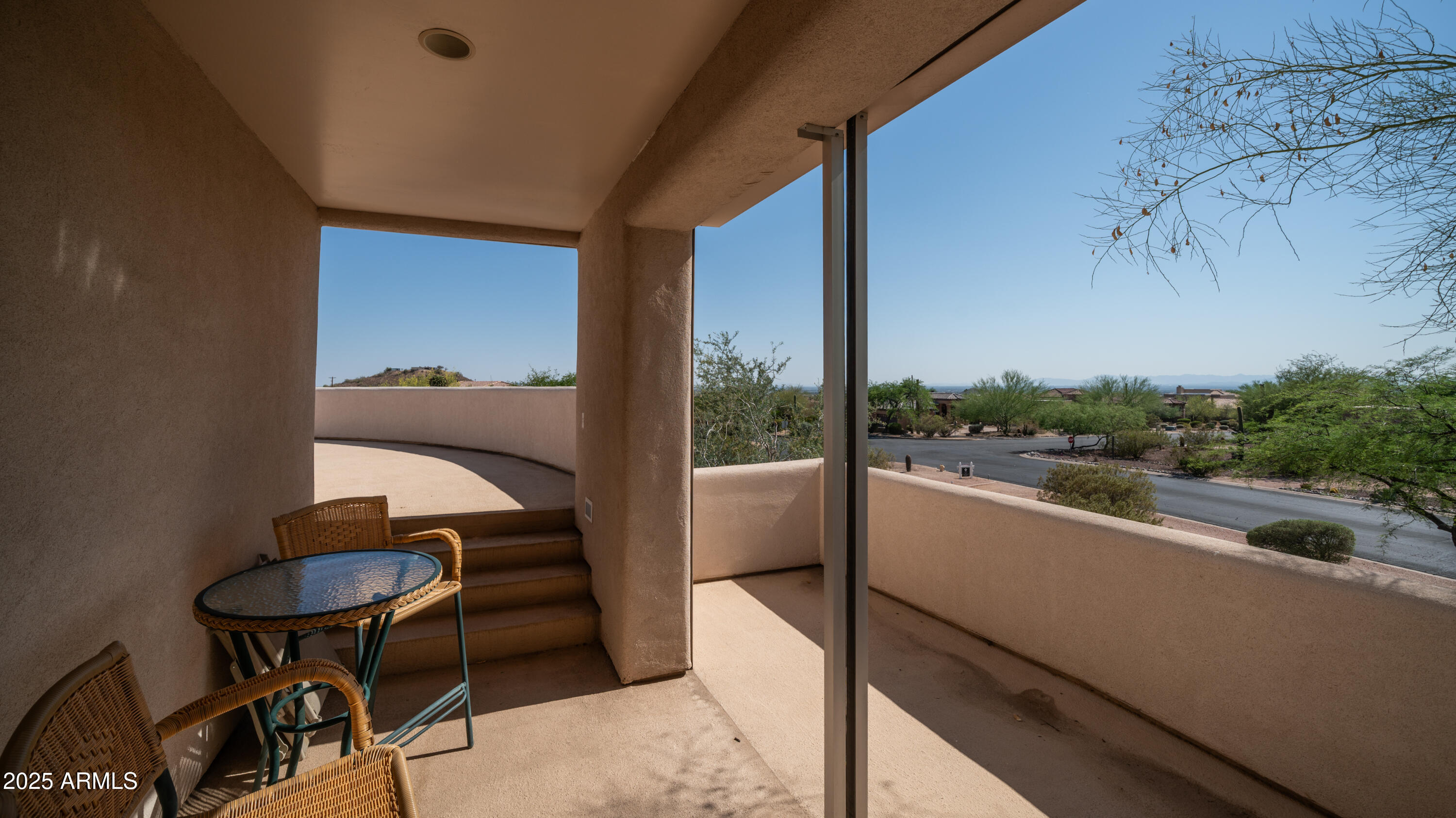 8540 East McDowell Road, Unit 116 Mesa, AZ 85207 - Photo 49 of 64 a view of a balcony filled with furniture and a potted plant