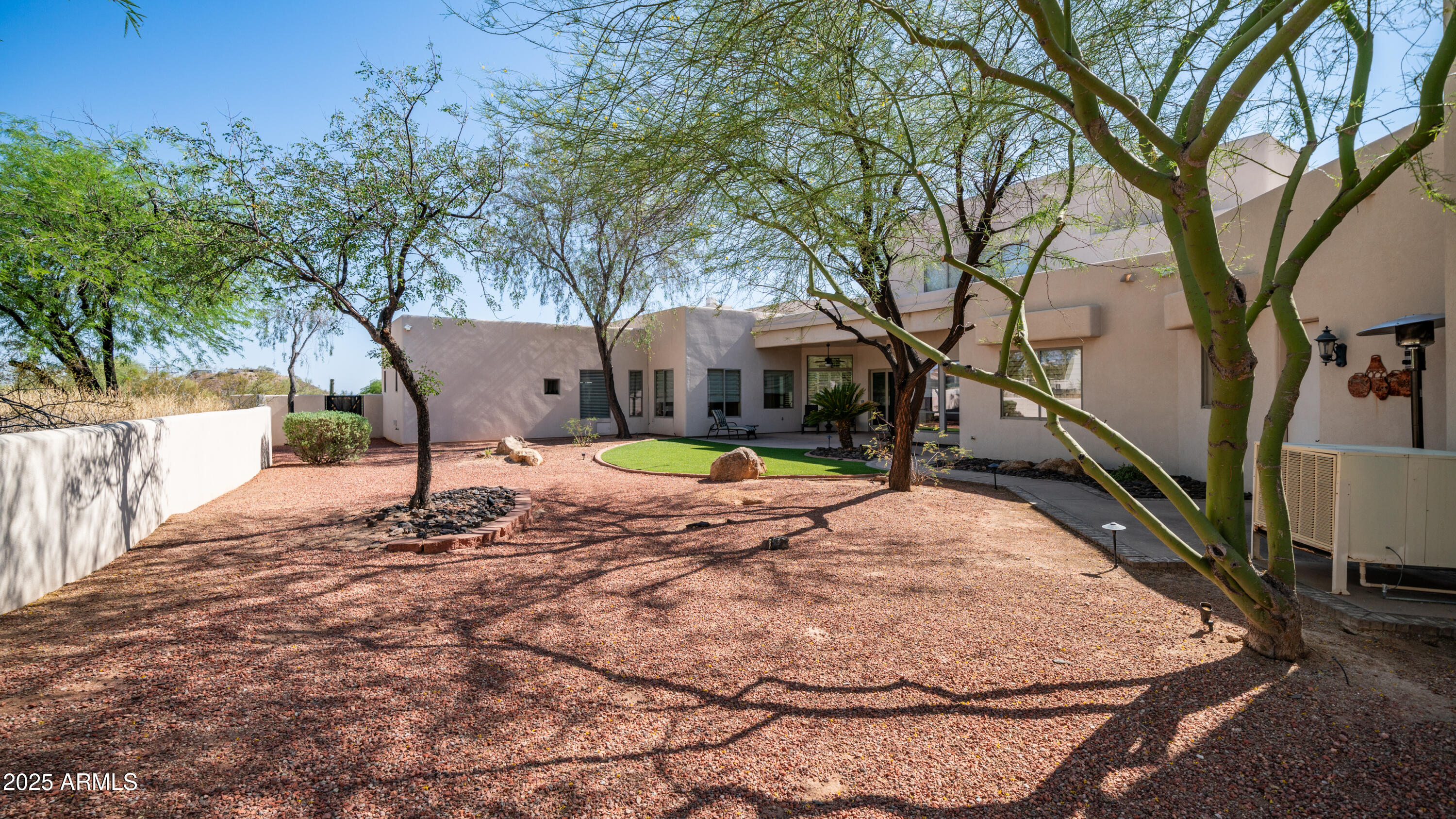 8540 East McDowell Road, Unit 116 Mesa, AZ 85207 - Photo 56 of 64 a view of a house with backyard and a tree