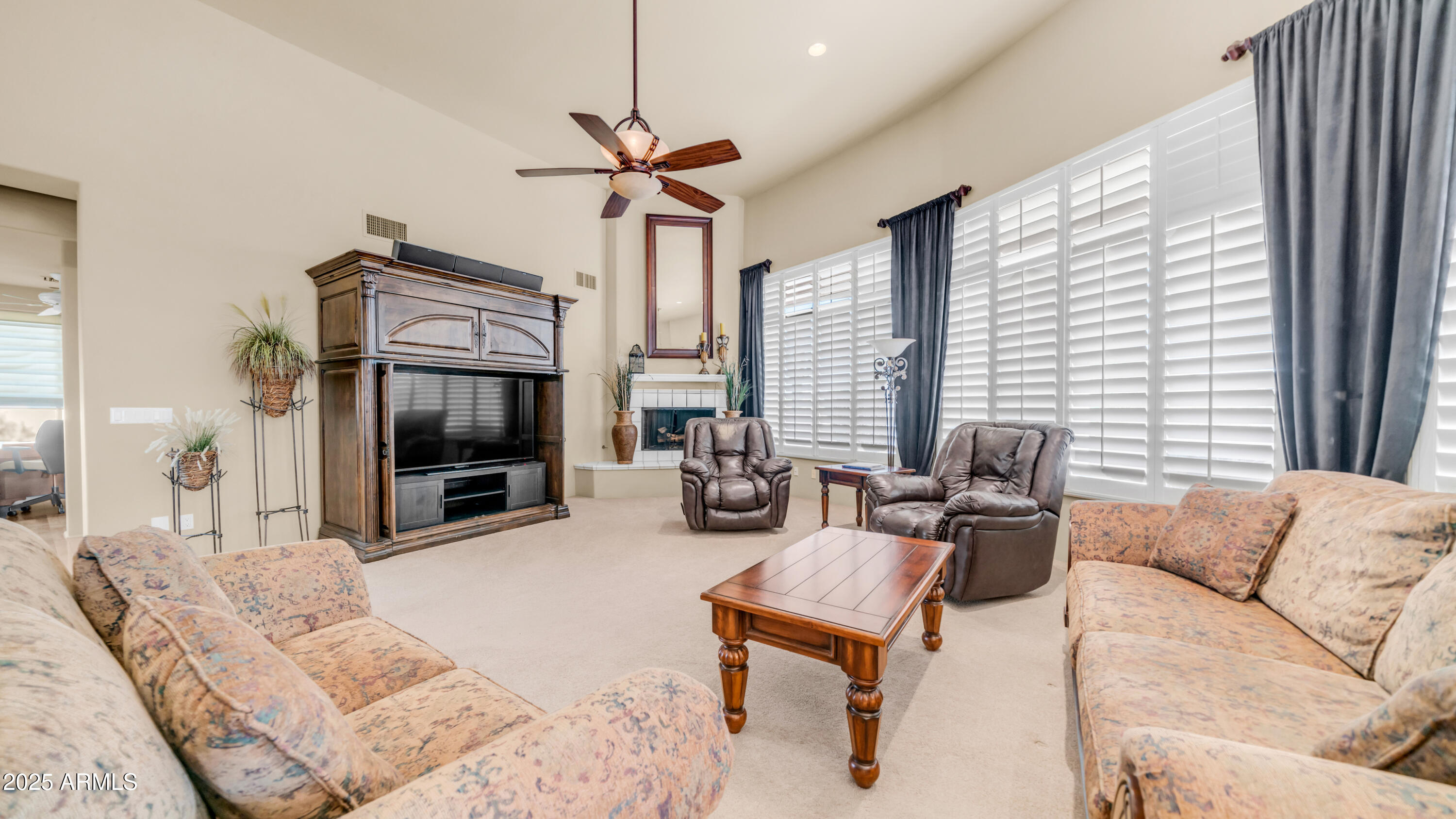 8540 East McDowell Road, Unit 116 Mesa, AZ 85207 - Photo 8 of 64 a living room with furniture ceiling fan and a flat screen tv