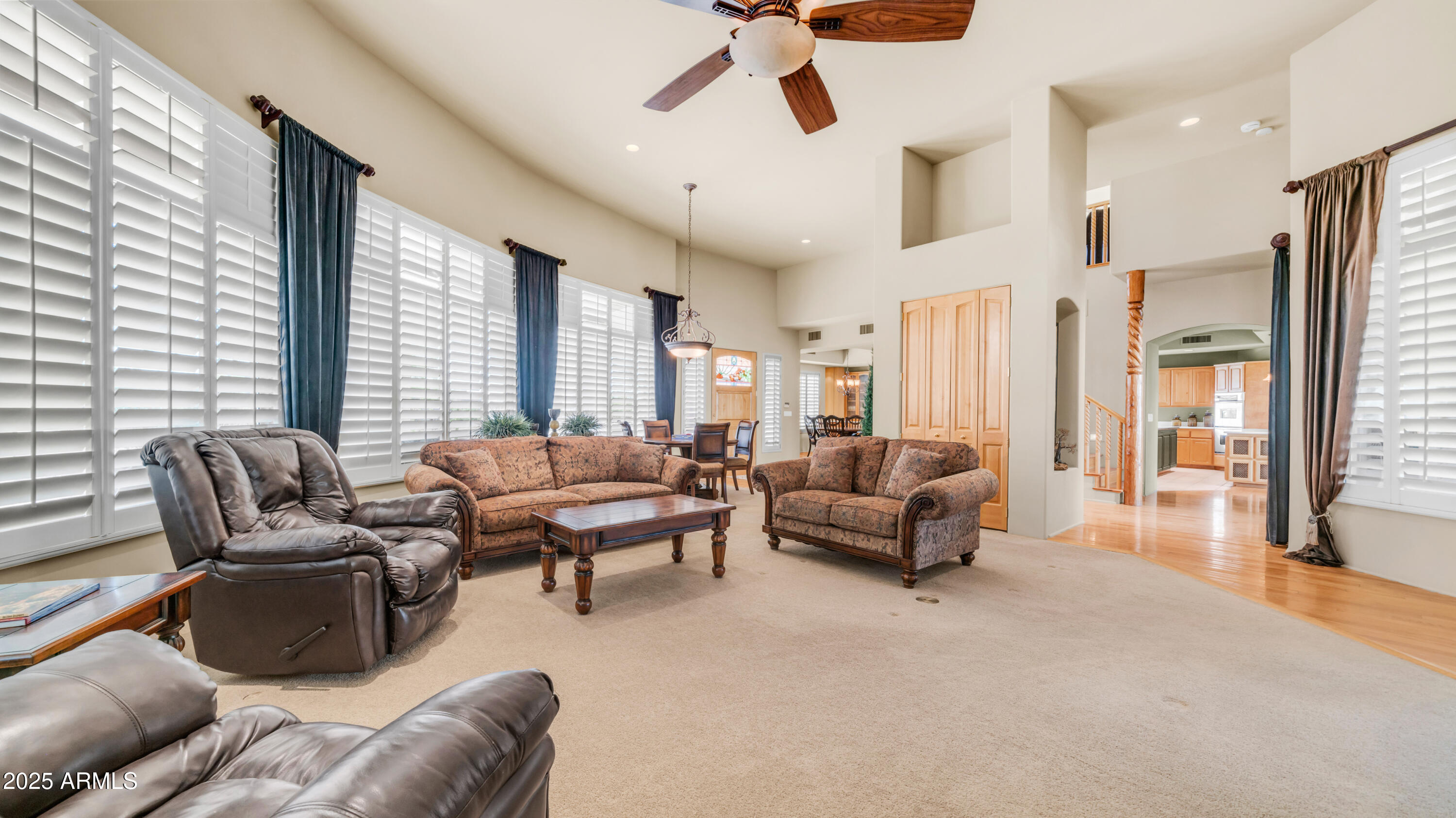 8540 East McDowell Road, Unit 116 Mesa, AZ 85207 - Photo 9 of 64 a living room with furniture and large windows