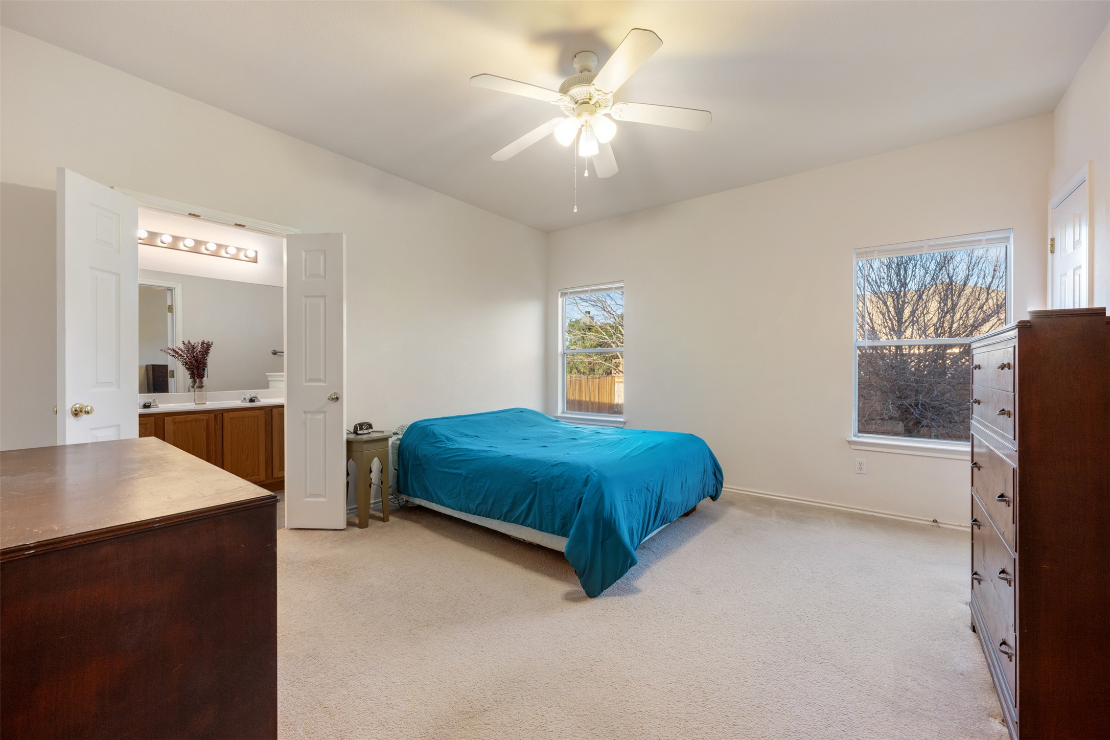 804 Estancia Way Leander, TX 78641 - Photo 10 of 40 a bedroom with a bed and a chandelier