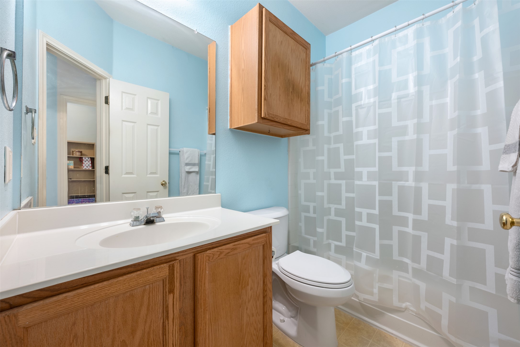 804 Estancia Way Leander, TX 78641 - Photo 15 of 40 a bathroom with a sink a toilet and shower curtain