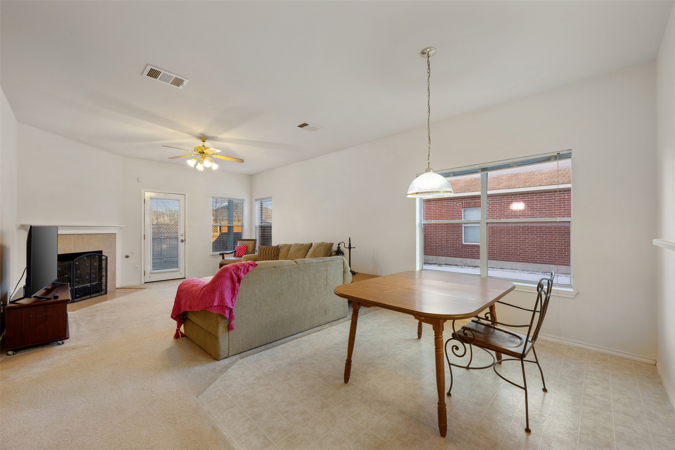 804 Estancia Way Leander, TX 78641 - Photo 8 of 40 a living room with furniture a fireplace and a chandelier