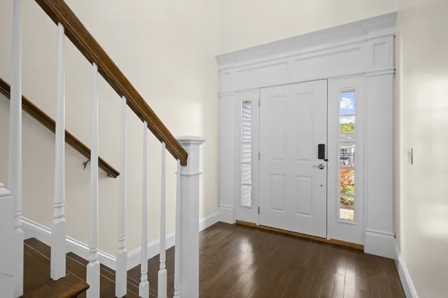 a view of an entryway with wooden floor