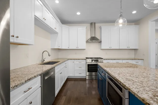 a kitchen with stainless steel appliances granite countertop a sink stove and cabinets