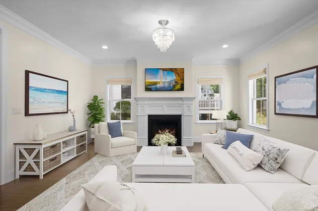 a living room with furniture fireplace and a window