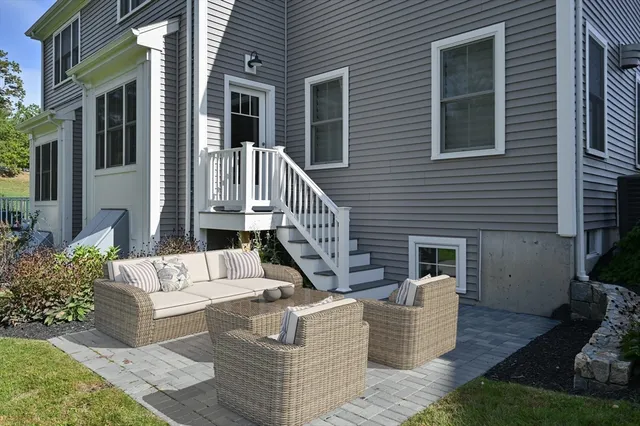 a view of a house with couches and a potted plant