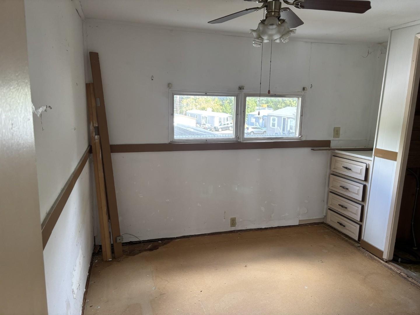 2933 Forebay Road, Unit 32 Pollock Pines, CA 95726 - Photo 13 of 15 a view of a kitchen with a window cabinet and a ceiling fan