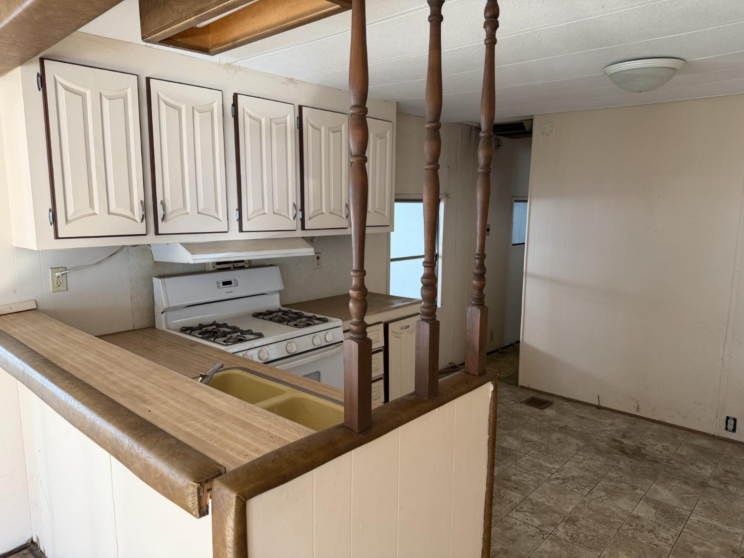 2933 Forebay Road, Unit 32 Pollock Pines, CA 95726 - Photo 4 of 15 a kitchen with stainless steel appliances granite countertop a refrigerator a stove and white cabinets