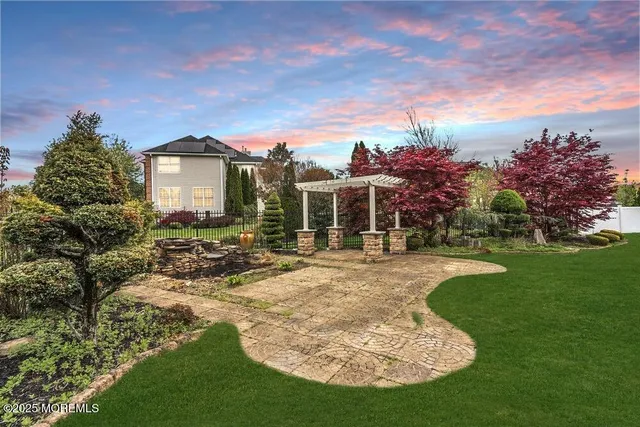 a view of a house with yard and sitting area
