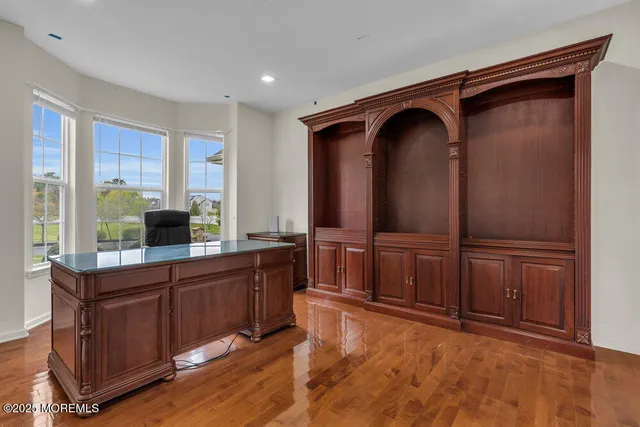 a view of room with wooden floor and furniture