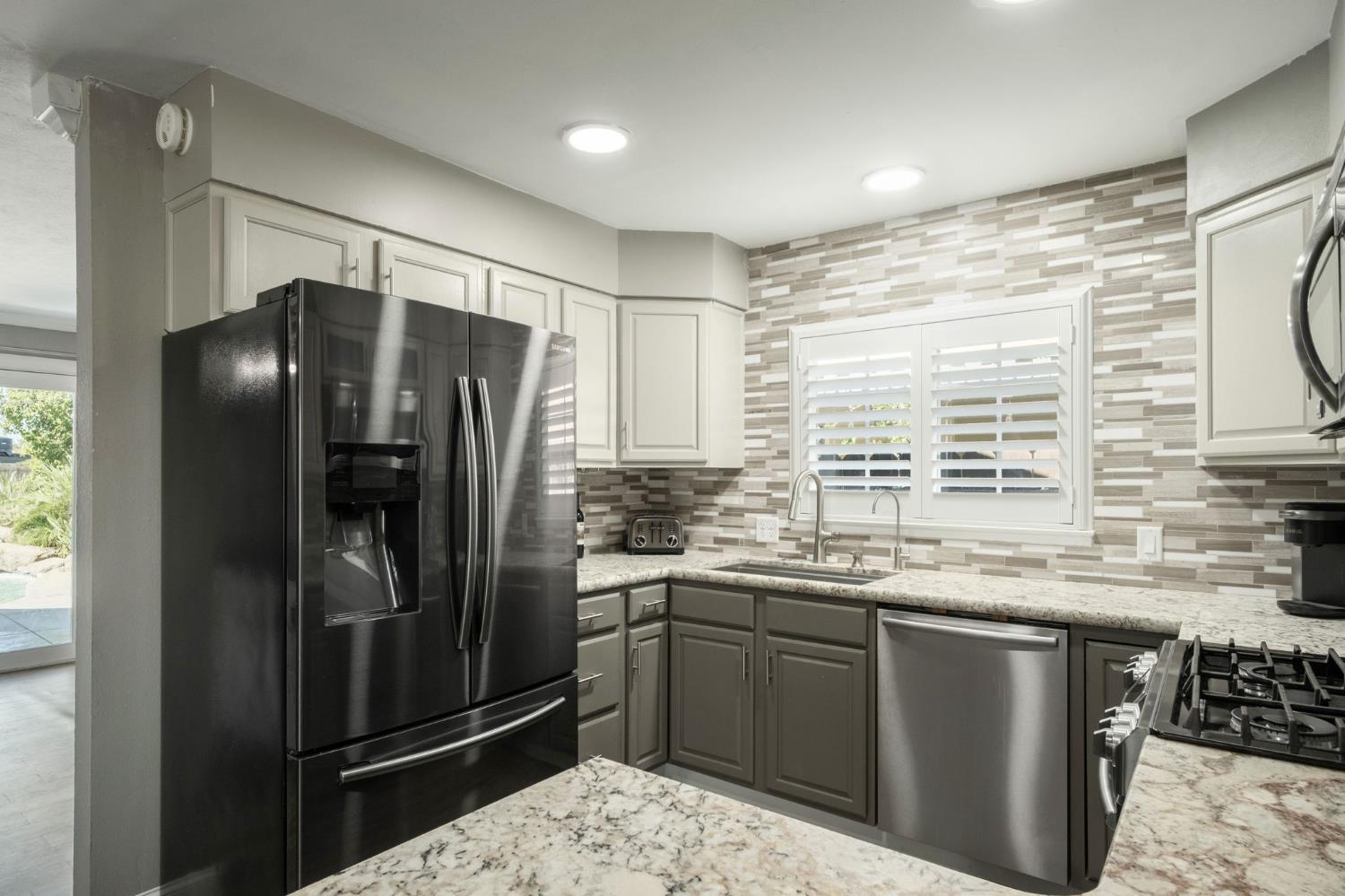 2604 Harvard Avenue Clovis, CA 93612 - Photo 15 of 28 a kitchen with stainless steel appliances granite countertop a refrigerator and a sink