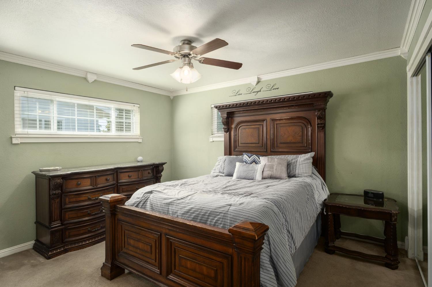 2604 Harvard Avenue Clovis, CA 93612 - Photo 16 of 28 a bedroom with a bed and a chandelier