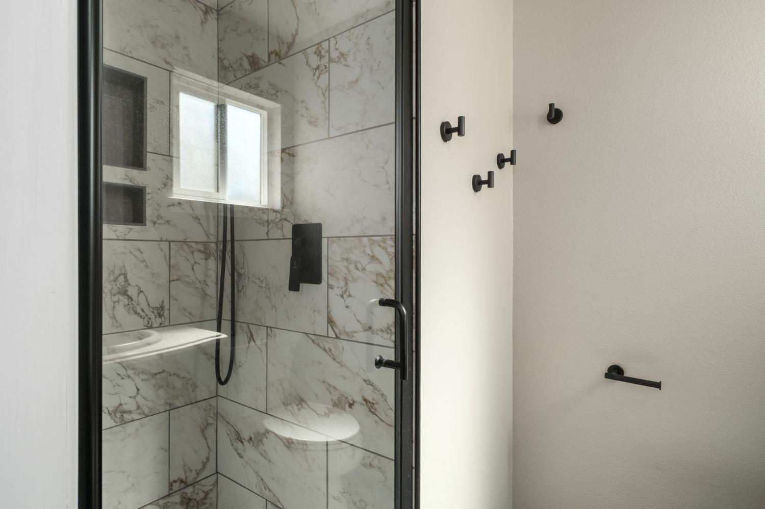 2604 Harvard Avenue Clovis, CA 93612 - Photo 18 of 28 a bathroom with a glass shower door