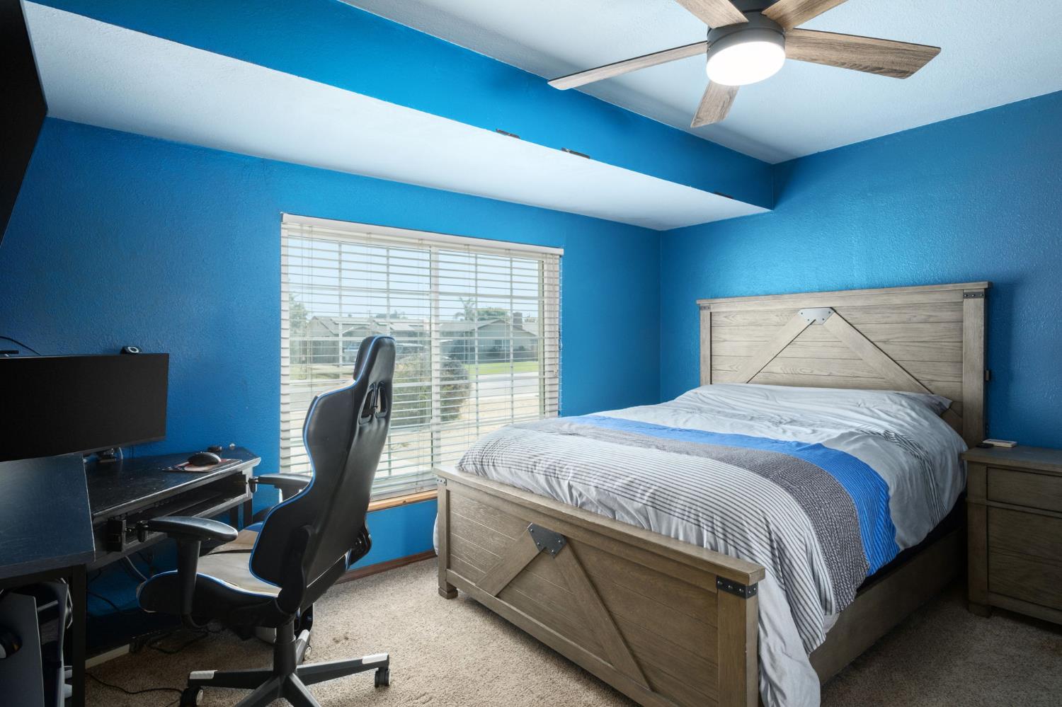 2604 Harvard Avenue Clovis, CA 93612 - Photo 19 of 28 a bedroom with a bed and a desk