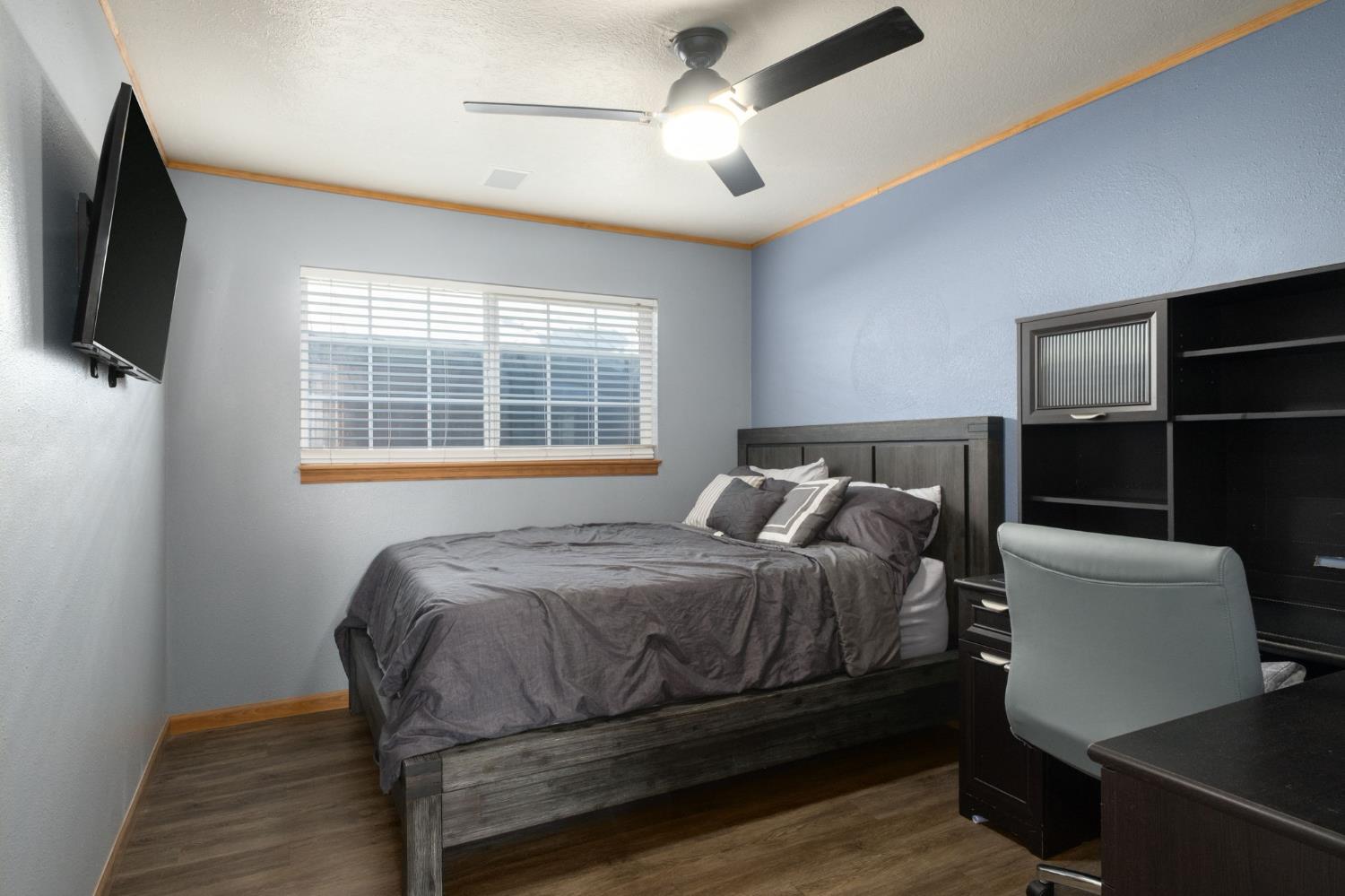 2604 Harvard Avenue Clovis, CA 93612 - Photo 21 of 28 a bedroom with a bed a flat screen tv and window
