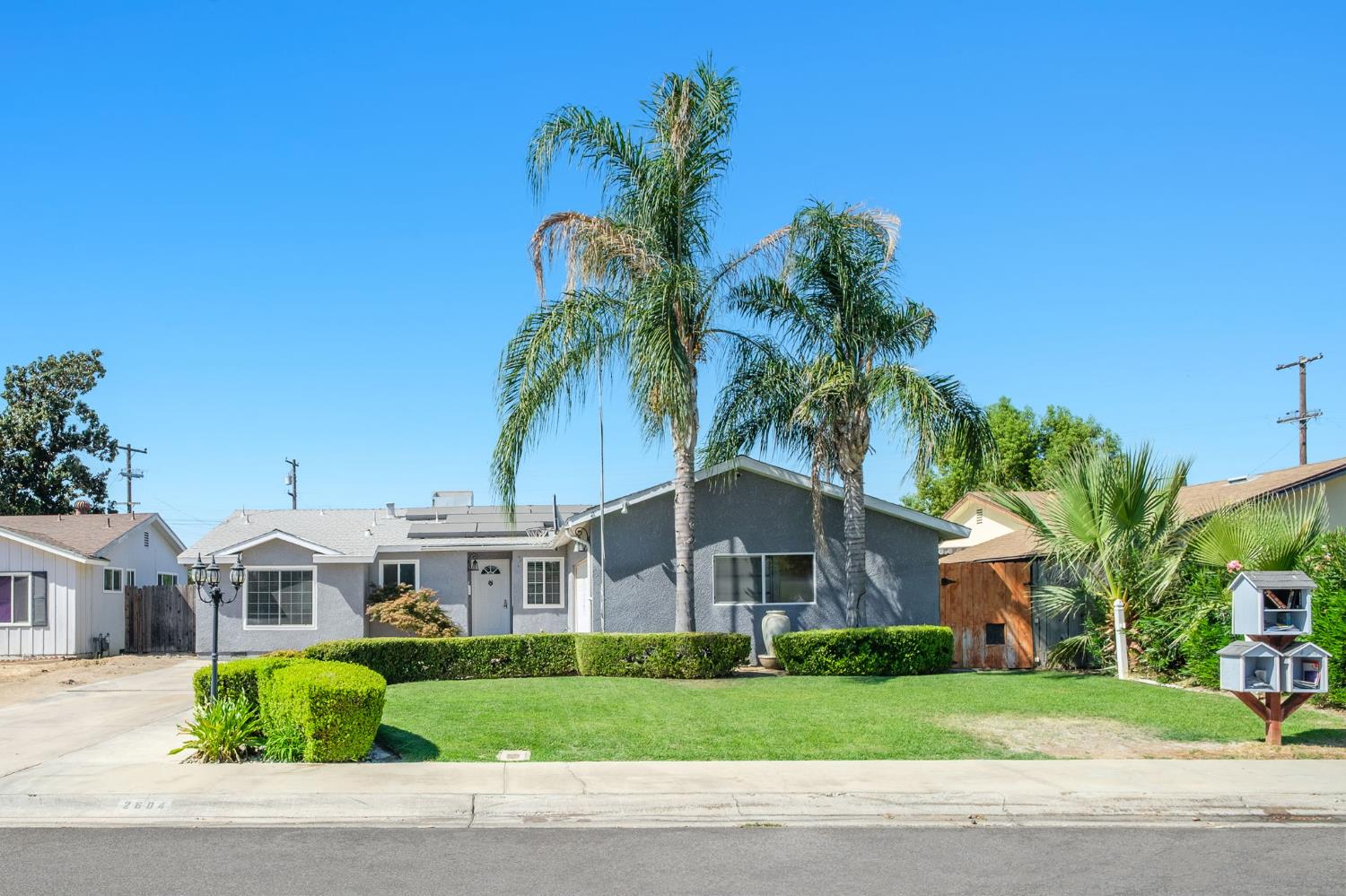 2604 Harvard Avenue Clovis, CA 93612 - Photo 28 of 28 a front view of a house with a garden and trees