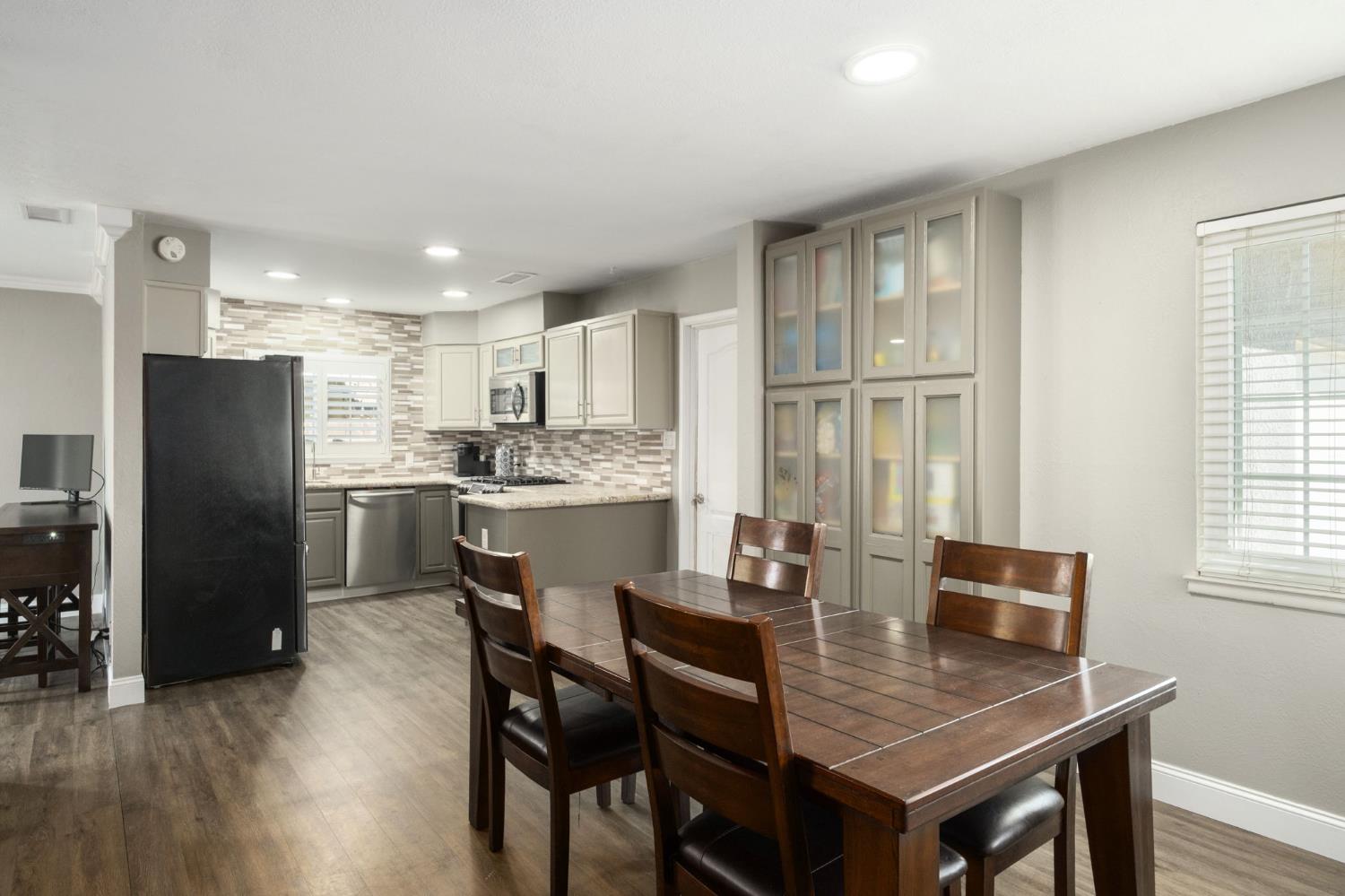 2604 Harvard Avenue Clovis, CA 93612 - Photo 7 of 28 a kitchen with a dining table chairs and refrigerator