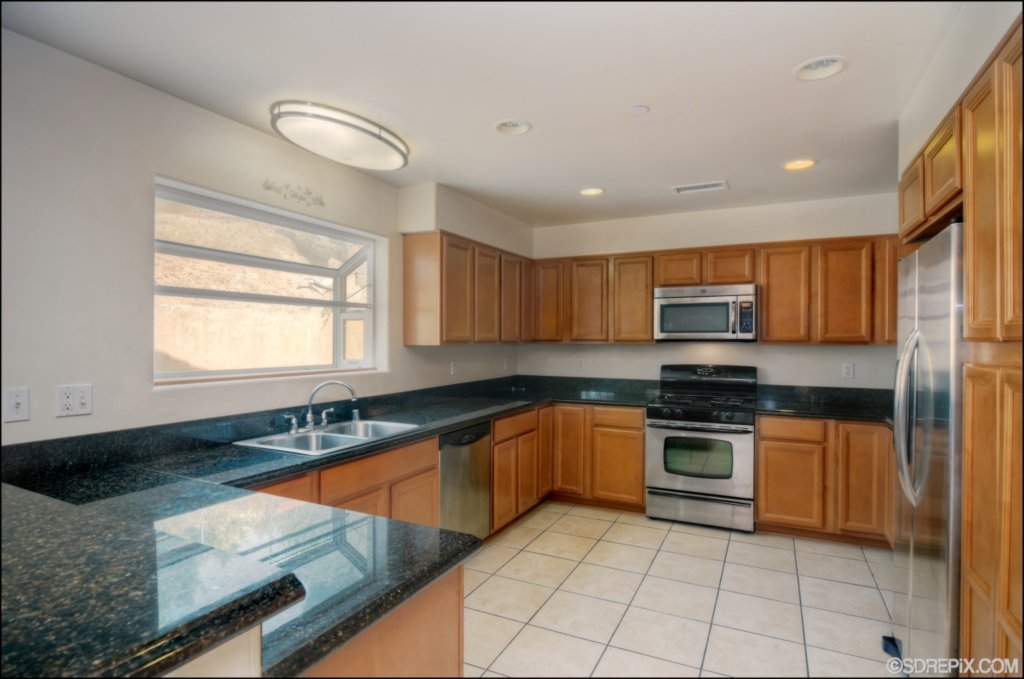10140 Casa De Oro Spring Valley Spring Valley, CA 91977 - Photo 8 of 24 Spacious Kitchen features granite countertops, stainless appliances, and tons of storage!